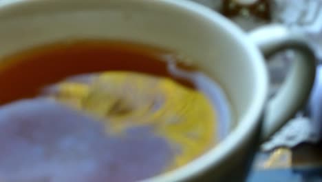 The-beautiful-reflections-of-a-tree-in-a-cup-of-tea-and-drops-of-tea-falling