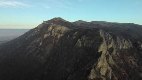 Aerial-shot-of-mountain-hill-with-forest-and-cliffs-8