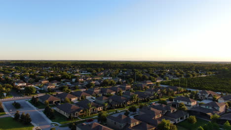 Panning-over-a-suburban-neighborhood-and-farm-during-dusk