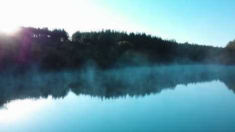 Foggy-lake-and-forest-early-morning---panning-shot