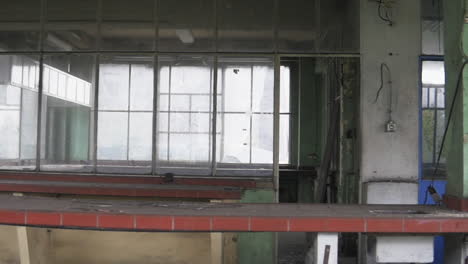 Inside-a-deserted-old-factory,-full-of-dust-and-decay