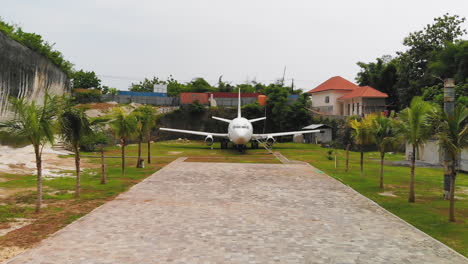 Drone-flying-straight-towards-and-over-the-famous,-abandoned-airplane-in-Bali