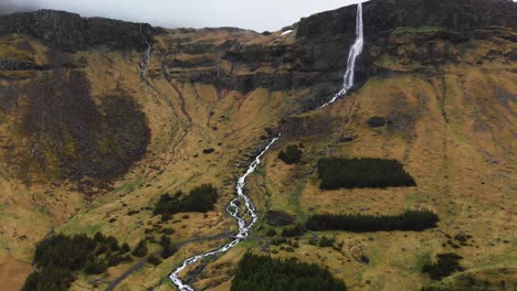 Aerial-video-going-towards-the-amazing-waterfall-Bjarnarfoss-located-in-the-high-mountains-of-Iceland