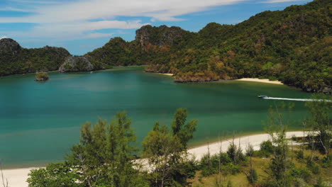 Slow-motion-aerial-footage,-tracking-a-tour-boat-near-Tanjung-Rhu-Beach-in-Langkawi