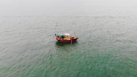 Slow-motion-drone-footage-of-an-isolated-old-Asian-fishing-boat