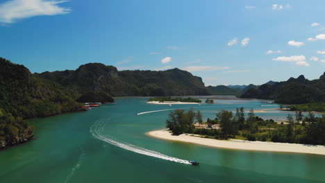 Slow-motion-drone-video-of-three-tour-boats-sailing-out-near-the-Tanjung-Rhu-Beach-in-Langkawi