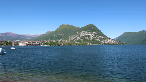Panning-shot-of-the-beautiful-coastline-in-Lugano,-Switzerland-during-a-sunny-day-3