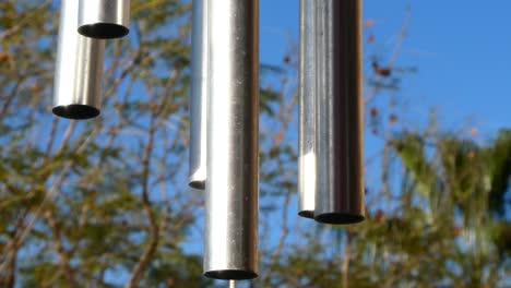 Close-up-view-of-the-tubes-of-a-wind-chime-hanging-in-the-nature