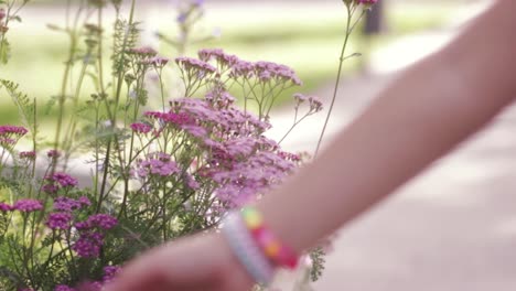 Hand-of-a-little-girl-touches-lilac-flowers