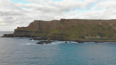 Beautiful-landscape-with-a-blue-ocean,-a-cloudy-sky-and-steep-cliffs-in-Northern-Ireland