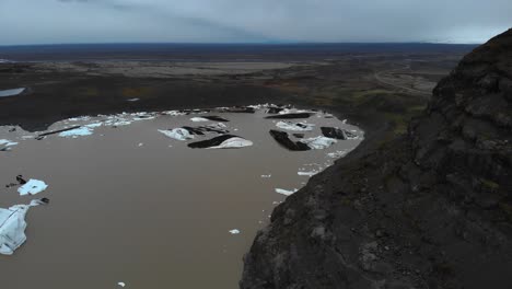 Aerial-footage-showing-the-Svinafellsjokul-glacial-point-with-lots-of-melted-ice-in-brown-water