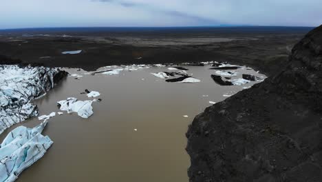 Aerial-footage-showing-the-Svinafellsjokul-glacial-point-with-lots-of-melted-ice-in-brown-water-2