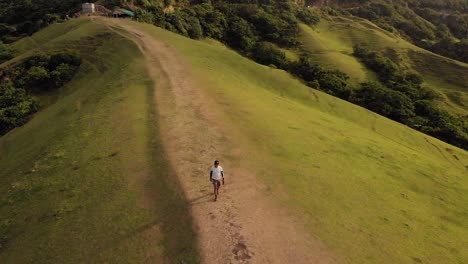 A-man-walking-on-top-of-a-hill-in-Batanes