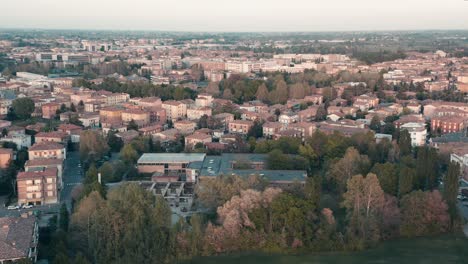 Aerial-–-Cinematic-revealing-shot-in-the-park-of-a-city-during-sunset