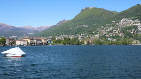 Panning-shot-of-the-beautiful-coastline-in-Lugano,-Switzerland-during-a-sunny-day-2