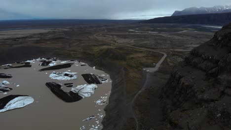 Aerial-footage-showing-the-Svinafellsjokul-glacial-point-with-lots-of-melted-ice-in-brown-water-1