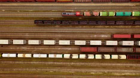 Aerial-view-of-colorful-freight-trains-with-goods-on-the-railway-station