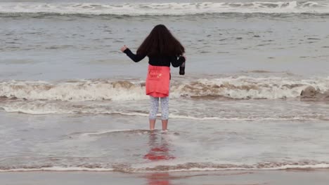 Young-girl-with-dark-hair-enjoying-Irish-sea-tide-on-the-coast-2