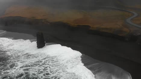 Aerial-footage-over-a-black-beach-in-Djupavogshreppur,-Iceland-4