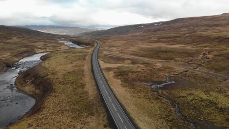 Aerial-footage-following-a-highway-that-leads-through-the-mountains-of-Iceland