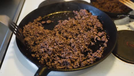 Frying-hot-ground-beef-on-a-cast-iron