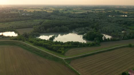 4K-Aerial-:-Fast-Cinematic-spotlight-shot-over-a-natural-lake-in-a-typical-italianrural-landscape