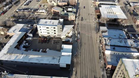 Flying-over-main-street-in-downtown-Bozeman,-Montana