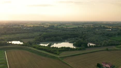 4K-Aerial-:-Cinematic-spotlight-shot-over-a-natural-lake-in-a-typical-italian-rural-landscape
