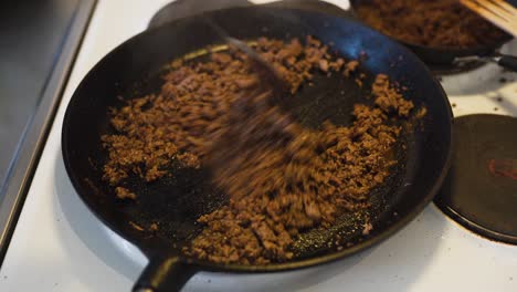 Putting-some-water-on-hot-ground-beef-covered-in-taco-spice