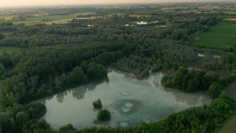 4K-Aerial-:-Cinematic-revealing-shot-over-a-natural-lake-in-a-typical-italian-rural-lanscape
