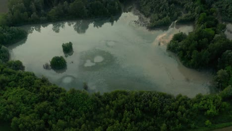 4K-Aerial-:-Cinematic-revealing-shot-of-a-country-landscape-with-a-reflective-natural-lake