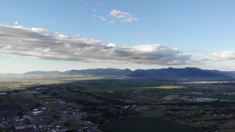 Drone-shot-over-a-small-town-and-the-mountains-in-the-distance