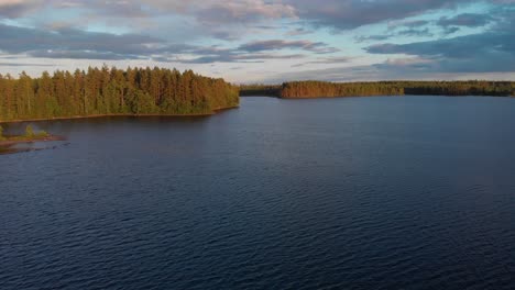 Aerial-footage-of-a-lake-in-a-Swedish-forest-during-sunset-3