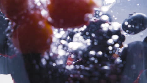 Slowmotion-of-assorted-berrys-falling-on-to-water-1