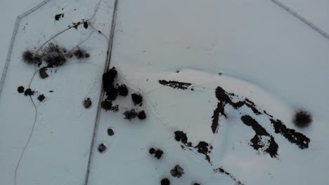 Overhead-drone-shot-of-a-large-log-home-during-wintertime