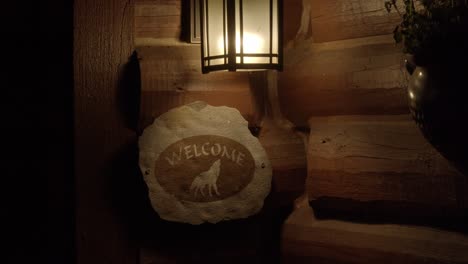 Welcome-sign-lit-during-the-evening-with-a-wolf-design