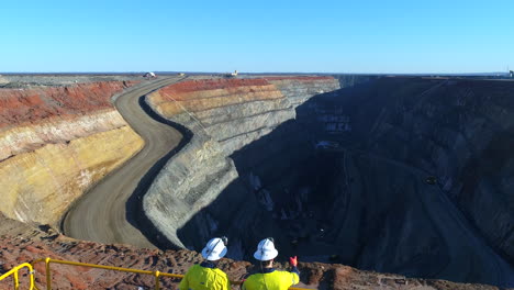 Fly-over-workers-looking-over-mining-pit