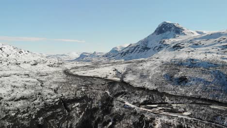 Scenic-aerial-of-a-mountainous-landscape-covered-in-snow