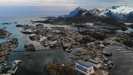 Cinematic-aerial-of-a-small-Scandinavian-island-town-with-mountains