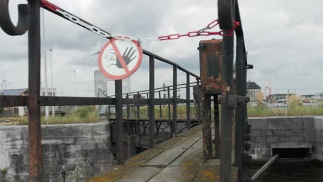 Cinematic-arc-shot-of-a-no-trespassing-sign-on-a-dry-dock-bridge