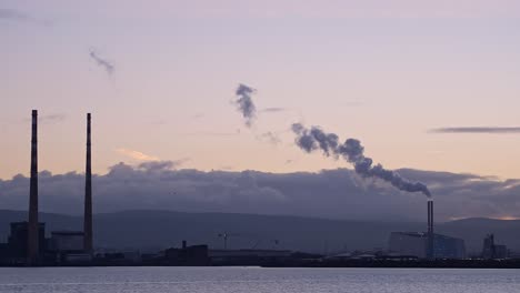 Industrial-features-at-Poolbeg-in-Dublin,-silhouetted-against-a-pastel-evening-sky