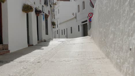 Slow-motion-zoom-of-a-white-Mediterranean-village-street-during-a-sunny-day