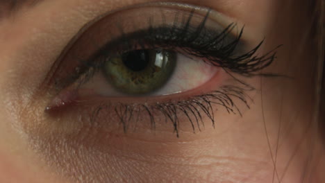 Close-up-of-a-young-Caucasian-girl's-green-eye-closing-and-opening