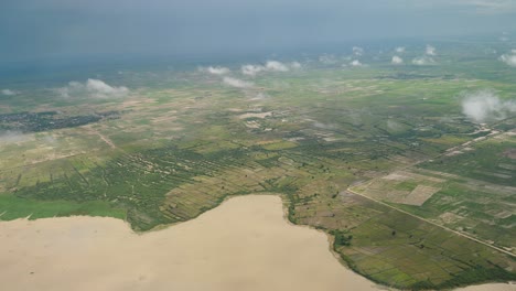 Aerial-view-of-green-field-and-lake,-Cambodia-1