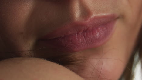 Young-Caucasian-female-biting-on-her-lip,-close-up-footage