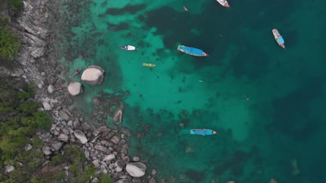 Aerial-view-of-parked-boats-at-the-rock-bay,-Koh-Tao,-Thailand
