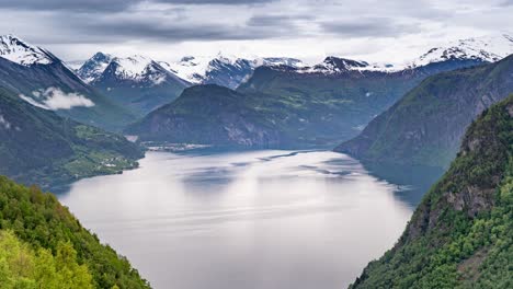 Breathtaking-and-tranquil-view-of-a-lake-surrounded-by-mountains-in-the-Valldalen-valley,-Norway