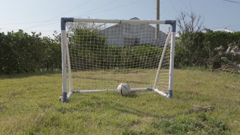 Soccer-ball-kicked-and-fly-then-roll-into-small-goal-net