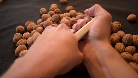 Young-man-is-cracking-some-fresh-dried-walnuts-7