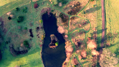 Pond-view-from-above-with-park-walkways-in-autumn-colour-in-Scotland